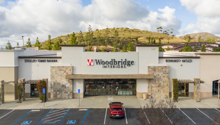 Storefront view of Woodbridge Interiors in San Marcos, CA with a spacious parking area